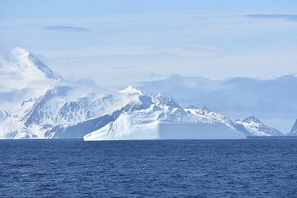 istock Snow-Covered Antarctic Mountain Range with Glacier Meeting the Ocean 2217589672