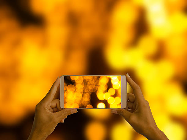 istock hand holding mobile photography bokeh 2217592768