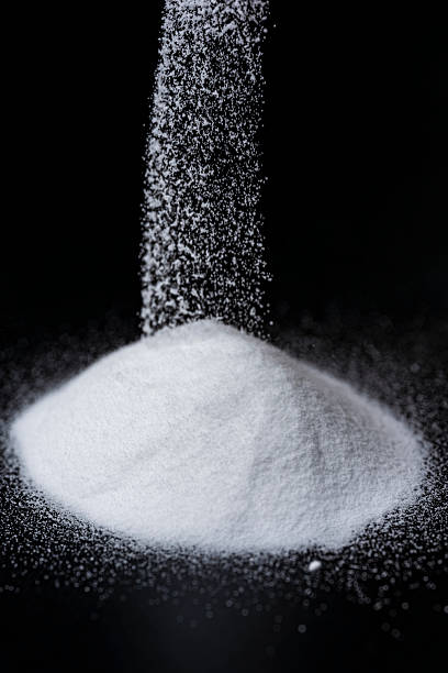 istock Baking Soda Powder Falling Against Black Background 2217593720