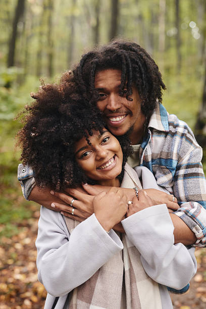 istock Happy black man embracing his girlfriend in nature. 2217594499