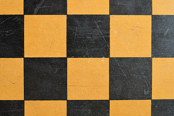 istock Horizontal table top view click of blank empty textured wooden tiled chess board with old scratched scuffed weathered run down surface 2217597977