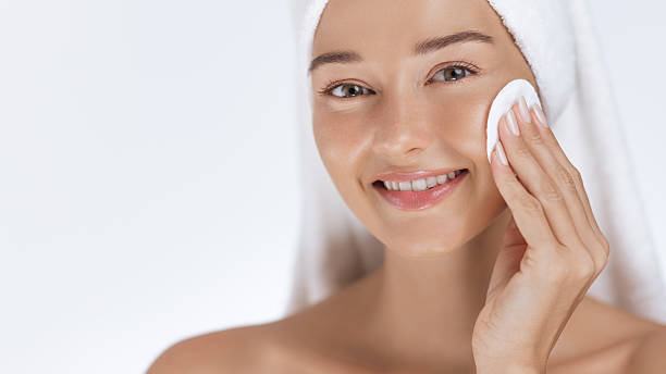 istock Happy Woman Doing Skincare Routine With Cotton Pad 2217598685