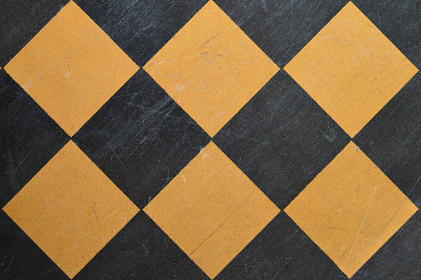 istock Horizontal table top view click of blank empty textured wooden tiled checked pattern chess board with old scratched scuffed weathered run down surface placed tilted so the squares appear rhombus or diamond shaped 2217598901
