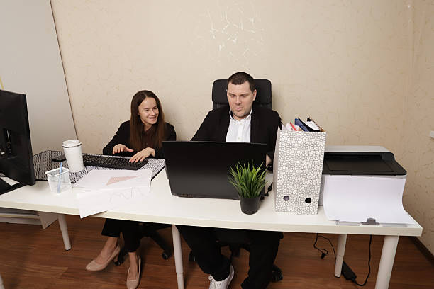 istock Professional Man and Woman Collaborating and Analyzing Business Reports in Office 2217598961
