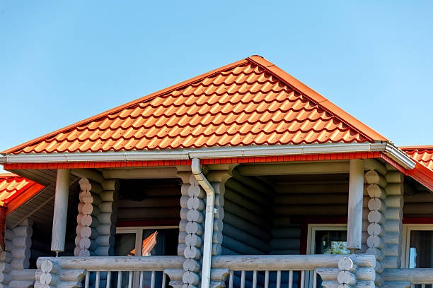 A house with a red roof and a white gutter. The roof is slanted and the house is made of wood