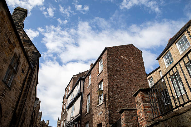 istock Old brick buildings and a summer sky in Durham city viewed from a low angle 2217601542