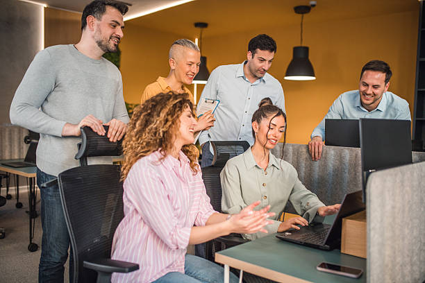 istock Group of business people having a teamwork discussion in a modern office environment, sharing ideas and documents 2217603501