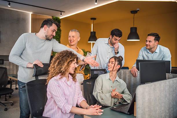 istock Smaller group of business colleagues having a teamwork discussion in a modern office environment, sharing ideas and documents 2217603890