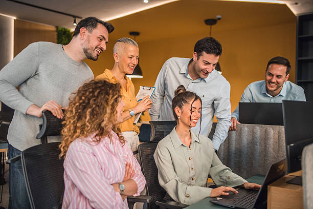 istock Smaller group of business people having a teamwork discussion in a modern office environment, sharing ideas and documents 2217603916