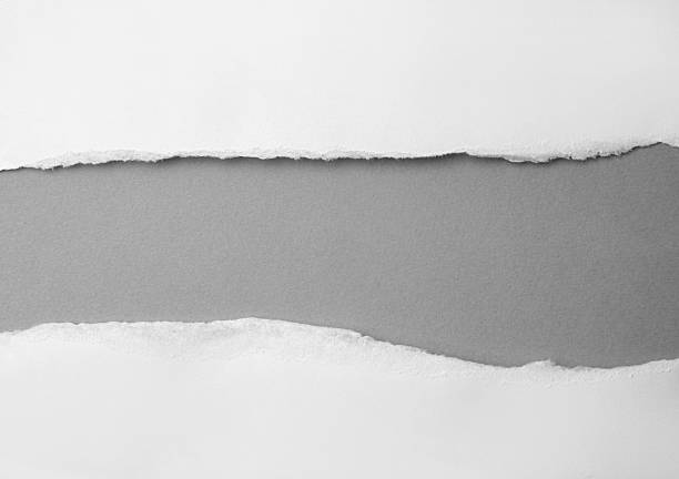 istock Hole ripped in white paper on gray background. 2217609318