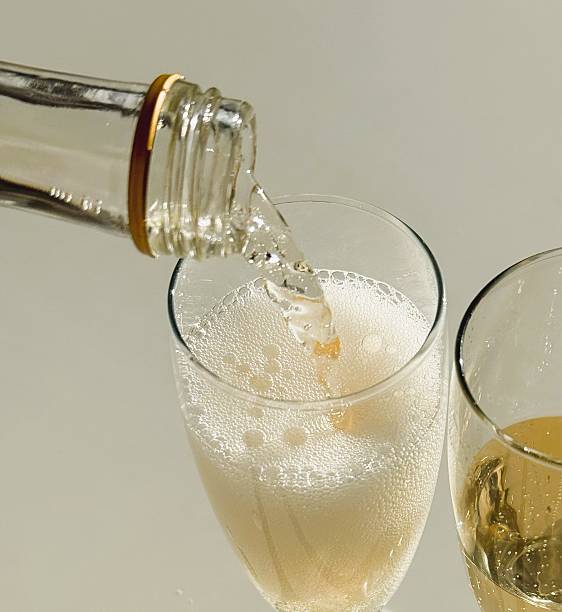 istock Pouring Pink Champagne into Glass 2217609446