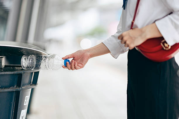 istock A close-up of a hand hesitating to drop a plastic bottle into a recycling bin, highlighting the impact of personal choices on the environment. Every small action contributes to sustainability and ecological responsibility. 2217612815