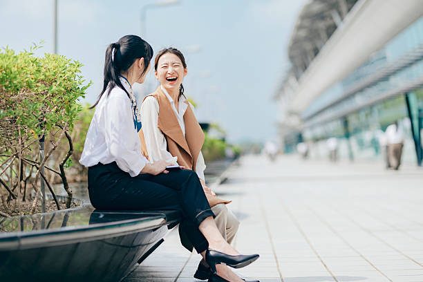 istock While waiting for a ride outside the station during a business trip, professionals engage in a work discussion, reflecting the flexibility of modern business and the power of real-time collaboration in a digital-driven world. 2217612913