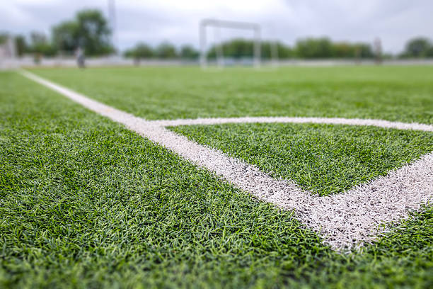 istock Football (soccer) field with new bright artificial surface. Corner marking. Training areas with small goals. Perfect solution that does not require maintenance in regions with water shortage. 2217613322