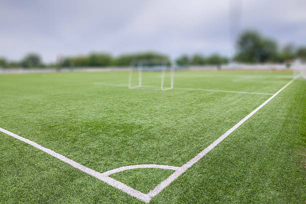 istock Football (soccer) field with new bright artificial surface. Corner marking. Training areas with small goals. Perfect solution that does not require maintenance in regions with water shortage. 2217613323