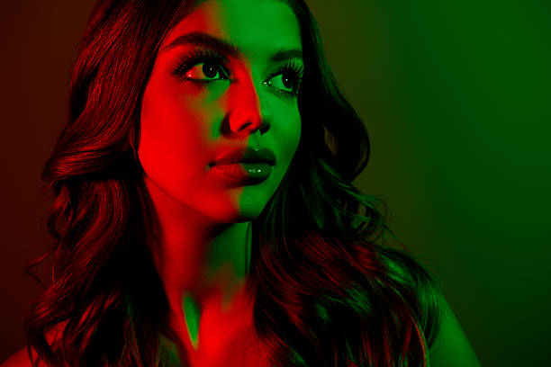 istock Portrait of attractive young lady looking empty space model isolated multicolor red green neon effect background 2217613968