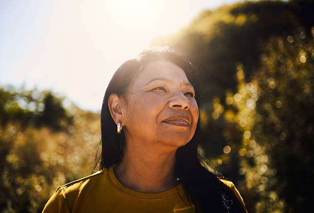 Confident Woman Smiling in Warm Sunlight