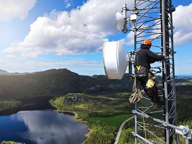 istock Engineer utility infrastructure worker at big steel mast working with radio link, microwave, 4G, 5G 2217618853
