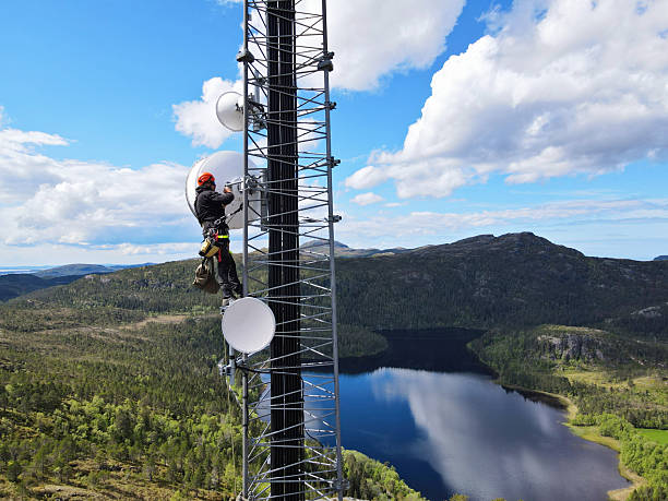 istock Engineer utility infrastructure worker at big steel mast working with radio link, microwave, 4G, 5G 2217619016
