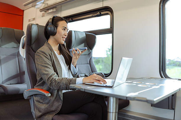 istock Professional woman working on laptop and talking on phone during train travel 2217620976