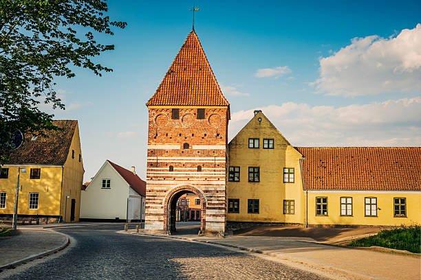 The medieval town of Stege, with the recently refurbished Gatehouse, or in Danish, “Mølleporten”, in the foreground. The Gatehouse is the only one of three that originally stood on the city walls that once guarded the town. Large parts of the moat and earth ramparts still surround the town. The tower dates back to the 16th century and is one of two that remain standing in all of Denmark.