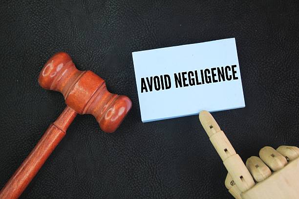 istock Judge's gavel and colored paper with the words avoid negligence. 2217623788