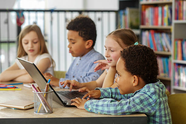 istock Children learning together on laptop in school. Back to school. 2217624876