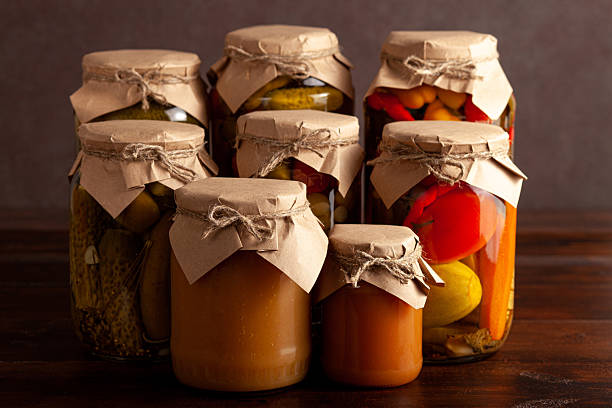 istock Assorted homemade preserves in rustic glass jars 2217624955