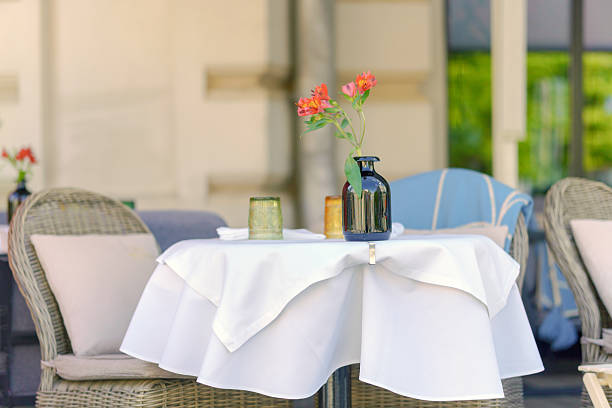 istock Delicate flowers on a table in an outdoor cafe. 2217627096