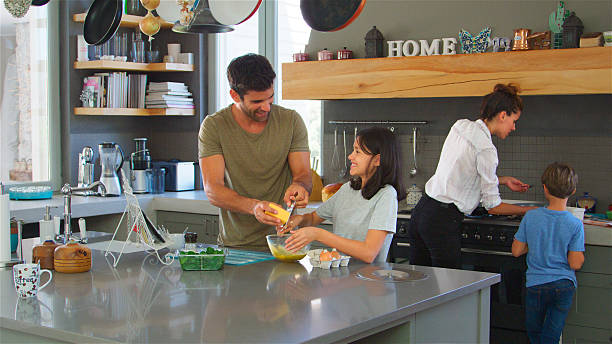 istock Family In Kitchen At Home Making Morning Breakfast Together 2217627104
