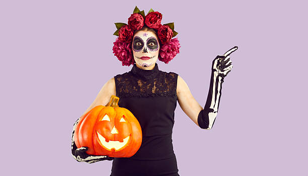 Girl with sugar skull makeup pointing with her finger to side