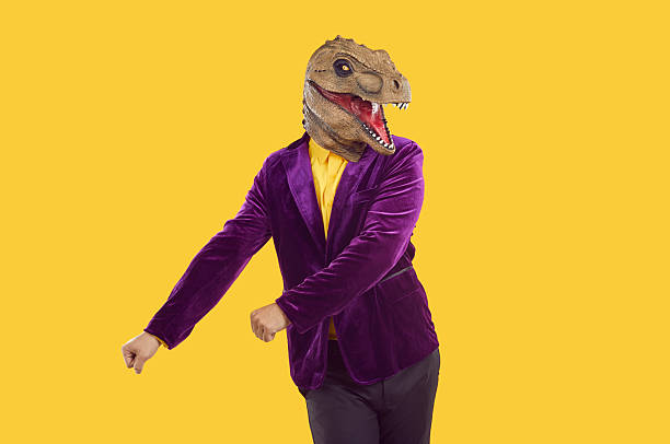 istock Funny cool man with laughing dinosaur head dancing 2217630355