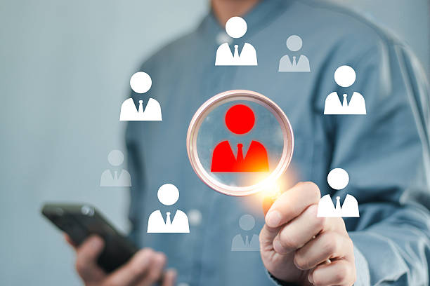 istock Businessman using magnifying glass Human resources, CRM, data mining, assessment center, and social media concept. officer looking for an employee represented by the icon. 2217630945
