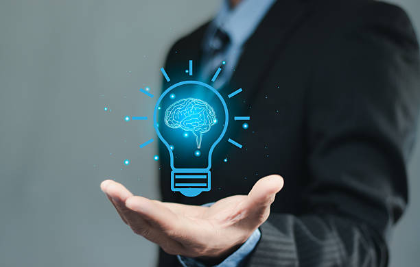 istock Hand holding drawing virtual lightbulb with brain on dark blue background for creative and smart thinking idea concept. new idea, innovation and inspiration, creativity. 2217631378