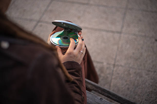 A woman takes her old MP3 and CD player, connecting it to check if it still works