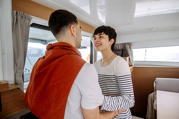 istock Smiling young couple sharing romantic moment at yacht cabin 2217633465