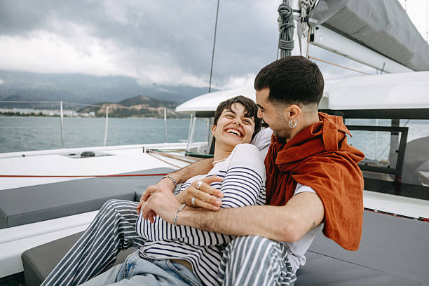 istock Young couple bonding while enjoying catamaran sailing trip together 2217633626