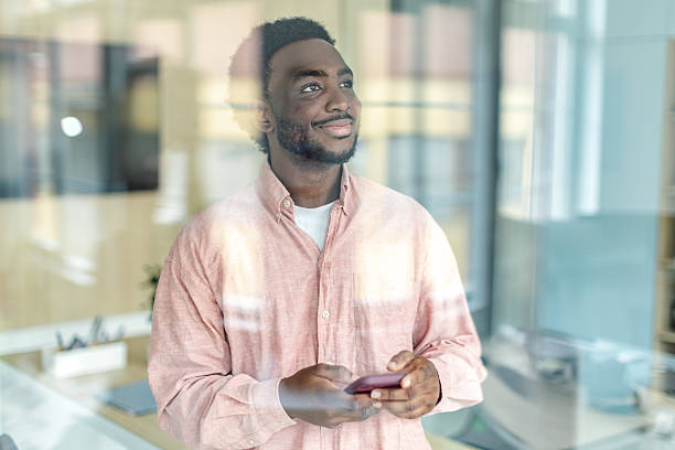 istock Young businessman confidently engaging with wireless technology in a modern office environment during the daytime 2217637028