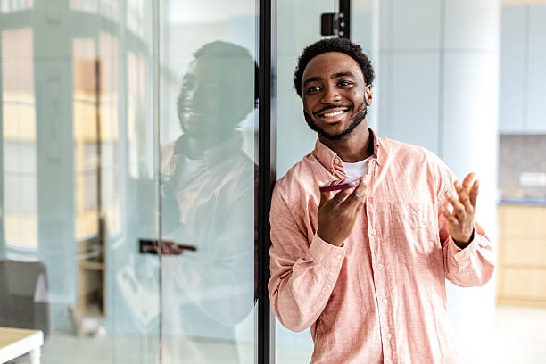 istock Young businessman expressing confidence and success in a modern office setting during work hours 2217637136