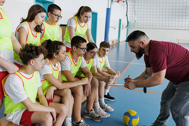 istock Trainer whit clipboard on sports training whit his team 2217639142