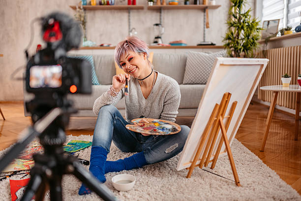 istock Young Female Artist Filming A Vlog Using A Camera On Painting And Art 2217639708