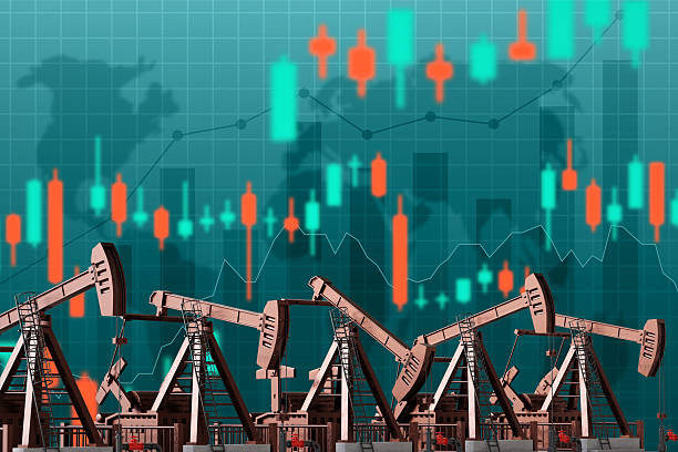 istock Oil pumpjacks with financial graphs and world map 2217639846