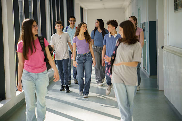 istock Group of children walking in school corridor 2217640433