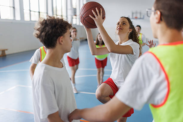 istock Girl playing basketball whit her team 2217640887