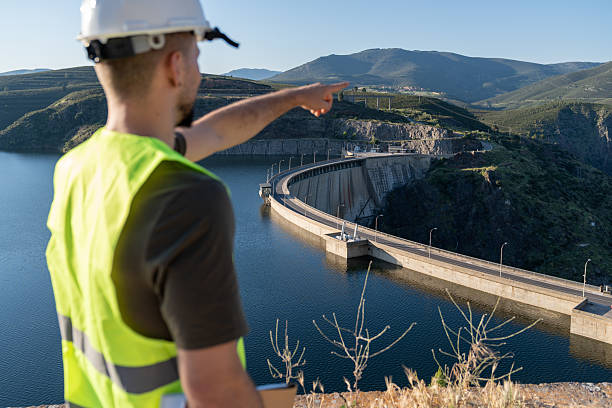 istock Engineer pointing at a hydroelectric dam for renewable energy 2217640947