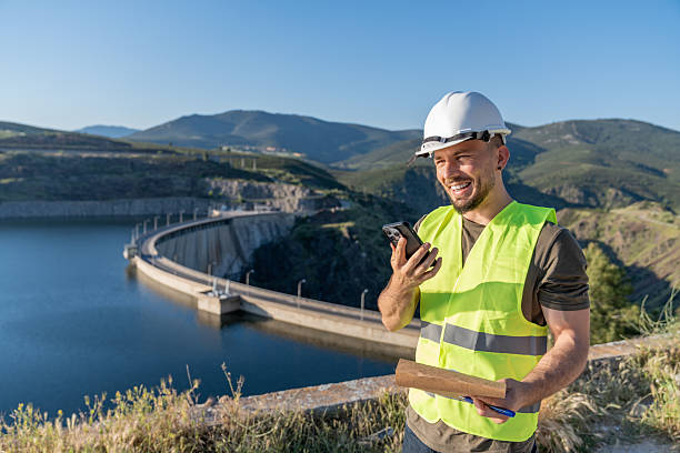 istock Engineer communicating near a hydroelectric dam for renewable energy 2217640948
