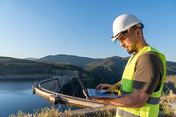 istock Engineer working with laptop at hydroelectric power plant dam 2217640961