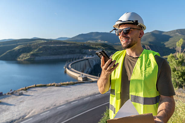istock Engineer communicating near hydroelectric dam for renewable energy 2217640962