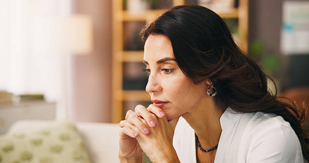 istock Thinking, stress and woman in home on sofa with anxiety for issue, problem and reflection in living room. Apartment, morning and thoughtful person with worry, overthinking and wondering in house 2217641328