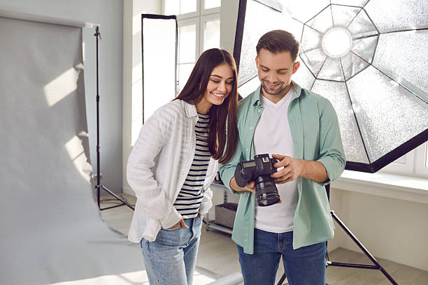 istock Photographer and model choosing best image after photo shoot together 2217643228